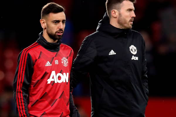 Manchester United manager Michael Carrick (right) says Bruno Fernandes (left) will continue as captain
