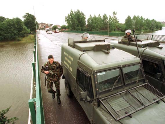 British Army soldiers and vehicles on a bridge in Belfast in the 1990s