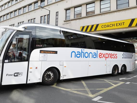 A National Express Coach leaving a depot
