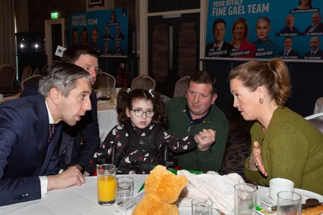 Tánaiste Simon Harris sought out Eimear Lynam at the end of the Budget Breakfast after she asked a question about help for parents of disabled children - Eimear (right) is pictured with husband Paul and daughter Kitty alongside John Clendennen TD
Pic: Niall O'Mara