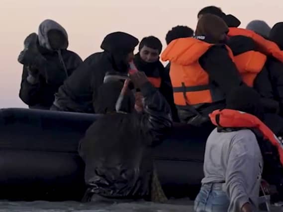A person holding what appears to be a knife as he tries to board a small boat