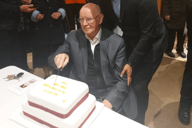 Fr Pat Kenny cutting his retirement cake