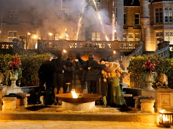 Claudia Winkleman and finalists watching a fireworks display the the end of the finale of The Celebrity Traitors