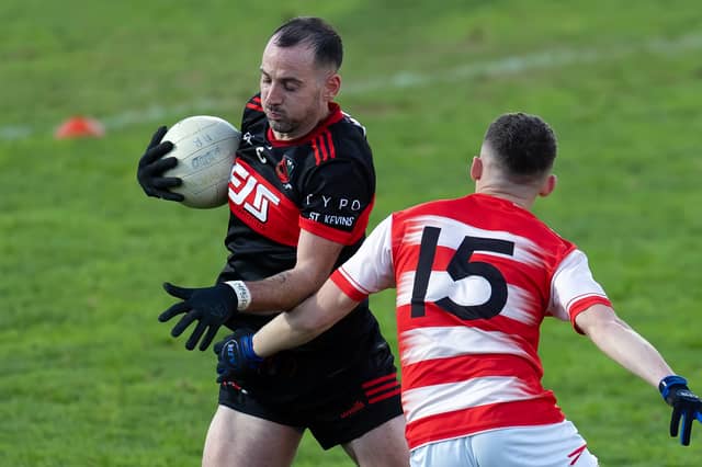 St Kevin's captain Mark Grace side steps the challenge of Cappagh forward Jack Mulligan in the Kildare JFC final