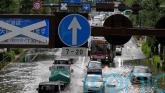 Heavy rain floods streets and halts air and rail travel in Tokyo