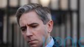 Woman in court charged with threatening Simon Harris