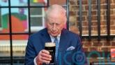 Charles plays barman and pulls the &lsquo;perfect&rsquo; pint of Guinness