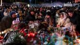 Mourners lay flowers as Swiss investigators probe fatal fire at ski resort bar