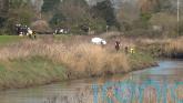 Divers recover body of teenage girl from river as search continues for male