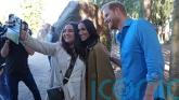 Harry and Meghan pose for selfies with public during walking tour