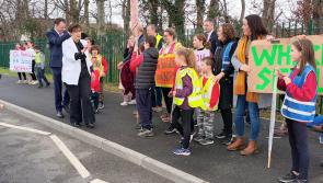 Protest greets education minister's visit to open new school