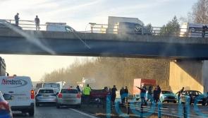 Woman in critical condition after car falls from bridge on to motorway