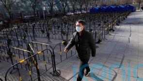 Beijing seals off more residential areas as Covid cases increase