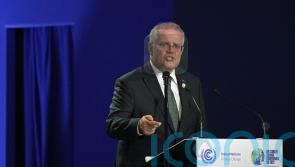 Australia’s prime minister to continue work after testing positive for Covid-19