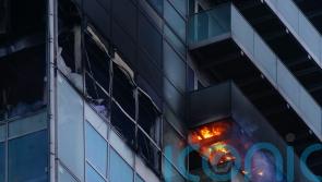 Woman rescued from fire at high-rise block of flats and offices in east London