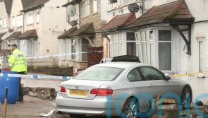 Pedestrian killed as car crashes into house