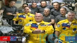 Russian cosmonauts wear Ukraine colours to International Space Station