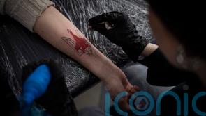 Patriotic messages in tattoos and on billboards become popular in Ukraine
