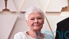 Dame Judi Dench graces Oscars red carpet on the arm of TikTok famous grandson