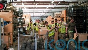 Hats off to Ukraine – UK soldiers pitch in to pack helmets destined for warzone