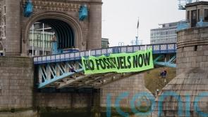 Extinction Rebellion activists abseil off Tower Bridge in climate protest