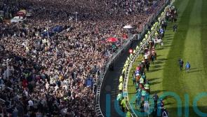Sell-out crowd cheers on Grand National as punters return to races