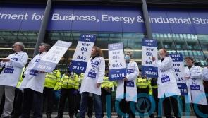 Activists glue themselves to Government building in climate protest