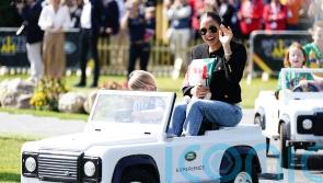 Harry and Meghan go for a spin in mini cars driven by children at Invictus Games