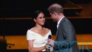 Meghan says she could not love or respect ‘incredible’ Harry more as pair kiss