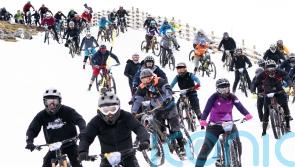 Hundreds of daring mountain bikers in 900m descent of snow-capped mountain