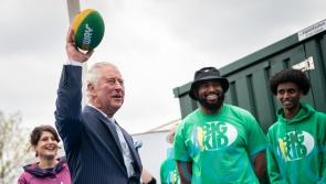 Charles tries American football on visit to charity
