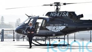 Tom Cruise lands helicopter on aircraft carrier for Top Gun sequel red carpet