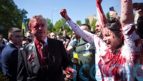 Russian ambassador to Poland hit with red paint by protesters
