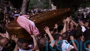 Pallbearers drop journalist’s coffin as Israeli police hit mourners with batons
