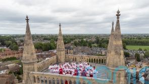 Choir sings from top of 163ft tower at Cambridge college