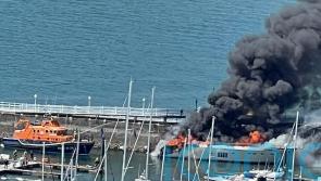 Work under way to prevent pollution after burning superyacht sinks in marina