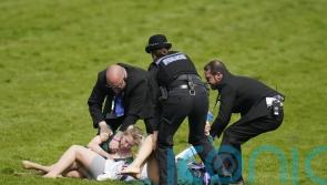 Animal activists taken away by police after running on track at Epsom Derby