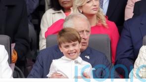Louis shares cuddle with Charles as he sits on his grandpa’s lap