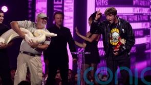 Jackass star joined onstage by enormous white snake at MTV Movie and TV awards