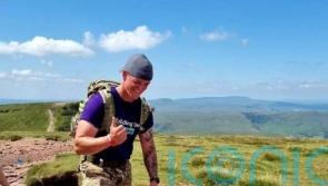 Soldier with PTSD carries rowing machine up mountain in world record attempt