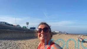 Self-conscious sea swimmer swaps sunrise or sunset dips in full wetsuit to lead 900-strong women’s open water group in bright pink costume