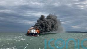 Two rescued after motor cruiser catches fire and sinks