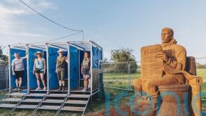 Huge mud toilet sculpture unveiled at Glastonbury to warn against climate change
