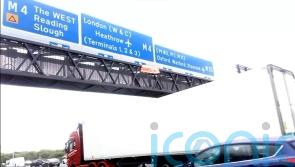 Five arrested as demonstrators climb motorway signs in climate protest