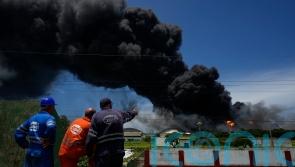 Firefighters battle big blaze at Cuba tank farm for second day
