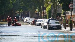 Roads closed as burst water main causes four-foot deep flooding