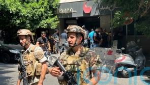 Armed man demanding savings holds Beirut bank staff hostage