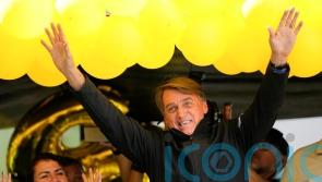 Brazil’s Bolsonaro grabs at heckler and tries to take phone
