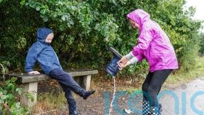 In Pictures: Umbrellas at the ready as dry weather gives way to downpours