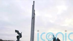 Soviet-era monument’s obelisk comes down in Latvia